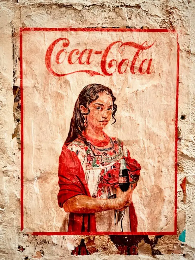 A painting of a woman holding a bottle of coca cola