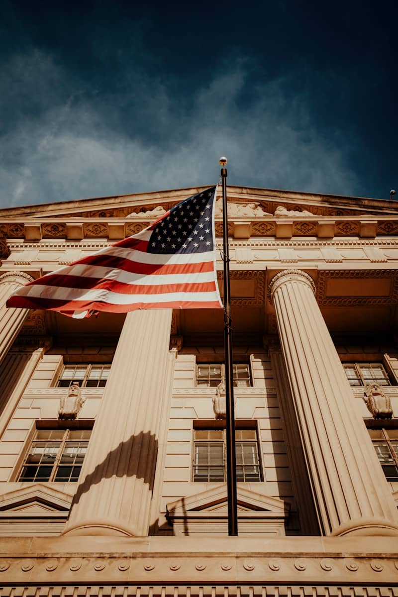 American flag flies proudly in front of building.